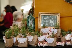 there are many small bags with flowers in them on the table next to each other