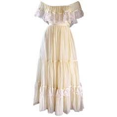 Breathtakingly beautiful 70s pale yellow soft cotton voile and lace maxi dress! Features an incredible amount of craftsmanship, with heavy attention to detail. Gives off just the right amount of Bohemian meets prarie peasant! Lace detail at bodice, which can be worn on or off the shoulders (see photos). Attached tiered skirt adorned with lace detail, with self tying back belt. Hidden zipper up the back with hook-and-eye detail. Such a beautiful versatile piece...would look AMAZING as a wedding d Off Shoulder Lace Dress, Vintage Pink Dress, Empire Maxi Dress, Dresses Yellow, Yellow Lace Dresses, 70s Maxi Dress, Yellow Maxi Dress, Yellow Maxi, Lace Dress Vintage