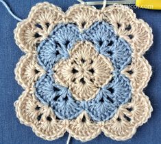 a crocheted doily with yarn and scissors