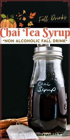 a glass jar filled with tea syrup next to an orange and white sign that reads chai tea syrup non alcoholic fall drink