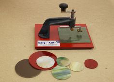 a sewing machine sitting on top of a table next to some cut up pieces of paper