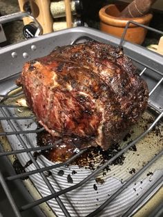 a large piece of meat sitting on top of a grill