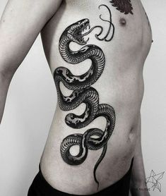 a man with a snake tattoo on his stomach