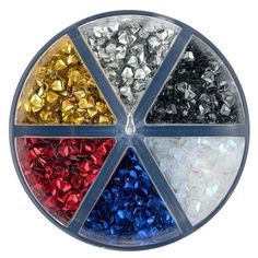 an assortment of different colors and sizes of beads in a circular display case on a white background