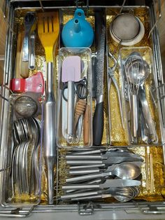 an open drawer filled with silverware and utensils