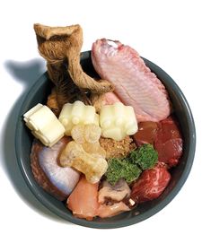 an assortment of meats and vegetables in a bowl