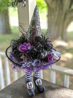 a purple and black halloween decoration on a porch