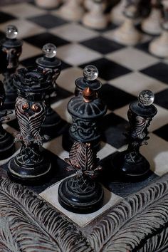 black and white photograph of chess pieces on a checkered board