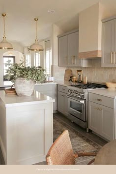 a kitchen with white cabinets and silver appliances