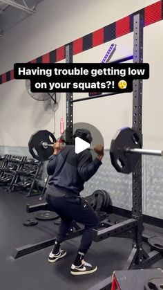 a man squats on a bench in a gym with the caption having trouble getting low on your squats?