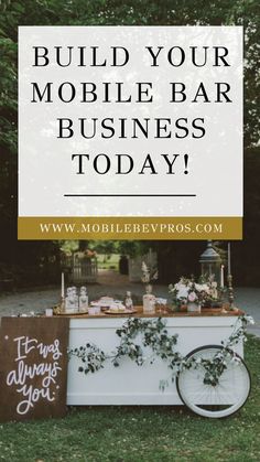 a mobile bar with flowers and greenery on it