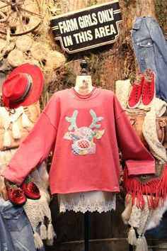 an assortment of clothing and hats on display in a store window with the words farm girls only in this area