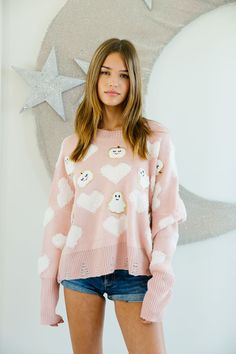 Get ready for a spook-tacular season with our HAPPY HAUNTINGS SWEATER. Featuring a playful combination of pink hearts, white pumpkin patches, and ghost patches, this cozy sweater is perfect for Halloween lovers. It's sure to keep you warm while also spreading some festive cheer. All orders are currently shipping within 14 business days. To receive item quicker, expedited shipping is available at checkout. **ALL HALLOWEEN ORDERS MUST BE PLACED WITH EXPEDITED SHIPPING TO GUARANTEE DELIVERY BY OCT. Playful Pink Loungewear Sweater, Playful White Sweater For Fall, Cute Pink Heart Print Sweater, Cute Heart Print Sweater For Fall, White Fun Sweater For Fall, Fun White Sweater For Fall, Girly Sweater, Judith March, Pumpkin Patches