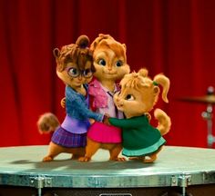 the three chipmuns are hugging each other on top of a drum