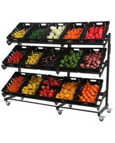 three tiered display with fruits and vegetables on it's sides in black plastic baskets