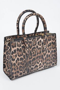 Turn heads with the Leopard Luxe Mini Tote, a bold and stylish statement piece perfect for any fashion-forward individual. This structured mini handbag, adorned in fierce leopard print, is designed for those who crave a touch of wild elegance in their wardrobe. Available in two striking colors—classic brown and sophisticated grey—this bag features double top handles and gold-tone hardware for a luxe finish. With a detachable shoulder strap, it effortlessly transitions from hand carry to crossbod