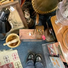 there are many items on the floor and one person is standing in front of them