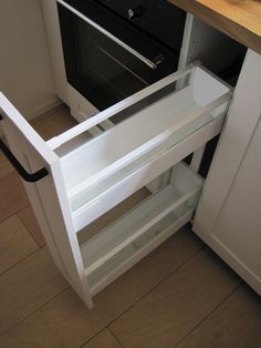 an open cabinet in the corner of a kitchen