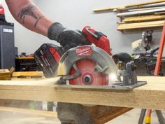 a man using a circular saw to cut wood