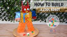 a robot made out of legos sitting on top of a wooden table with the words how to build a cool robot