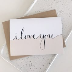 a card with the word i love you written in cursive writing on it