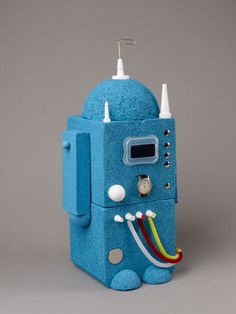 a blue robot shaped object sitting on top of a table