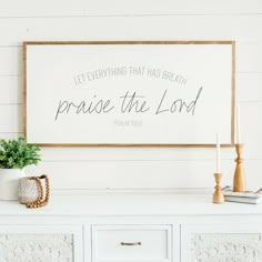 a sign that says, let everything that has breath praise the lord on it next to a dresser