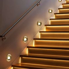 some lights that are on the side of a set of stairs