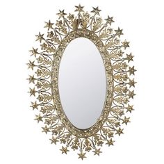 an oval mirror with gold stars around it