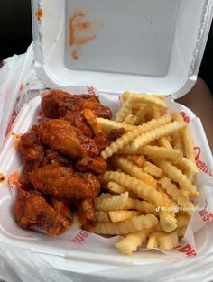 chicken wings and french fries in a takeout container