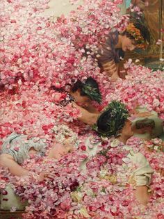 two women are surrounded by pink flowers in a room full of other people and one woman is laying down on the floor