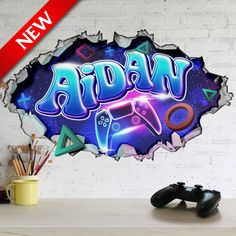 a wall sticker with the word oscar on it and video game controllers in front of it