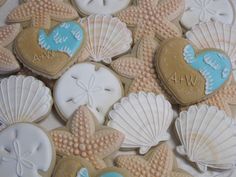 decorated cookies with shells and seashells are arranged on a table