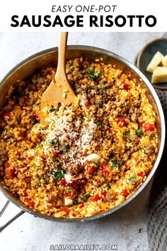 an easy one pot sausage risotto recipe in a skillet with a wooden spoon