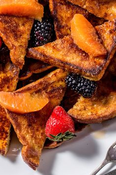 french toast with berries and oranges on a plate