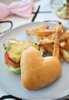 a heart shaped sandwich and french fries on a plate