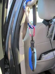 the interior of a car with an umbrella hanging from it's side door handle