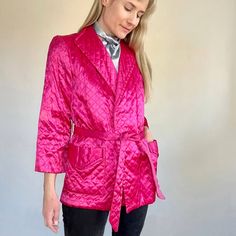 An Amazing Handmade 40s Hot Pink Satin Quilted Bed Jacket. It Has Large Pockets With Flaps, A Matching Belt And An Attached Silver Necktie (Style In The Front Or Tuck Behind If You Don't Want It To Show). Fully Lined And Has A Nice Thickness To It. Padded Shoulders. Lapels. Wide Cut Cropped Sleeves. Has A Beautiful Silhouette! Estimated To Fit A Small, But Please Check The Measurements Below. In Good Vintage Condition With Some Markings Towards The Interior Neckline, Interior Armpit Areas And On The Interior Side Of The End Of The Belt. Some Loose Threading Here And There On The Quilting. A Small Break To The Material On The Left Shoulder. See Photos. Presents Beautifully. Sold As Is. Label Quilted Bed, Satin Quilt, Bed Jacket, Beautiful Silhouette, Cropped Sleeves, Vintage 40s, Magenta Pink, Quilt Bedding, Pink Satin