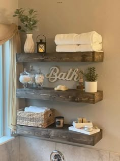 bathroom shelves with towels, candles and other items on them in the corner of a bath room