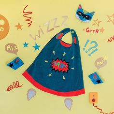 a blue bib surrounded by magnets and confetti on a yellow background