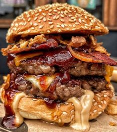 a hamburger with bacon, cheese and ketchup on it