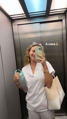 a woman taking a selfie in an elevator