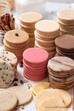 cookies and cookies are arranged on a table with cinnamons, orange slices, and chocolate chips