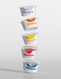 three containers of yogurt stacked on top of each other in the shape of a pyramid