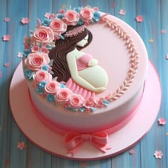 a pink cake decorated with flowers and a pregnant woman