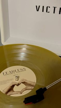 a yellow vinyl record sitting on top of a table