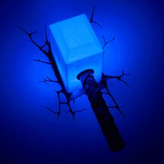 a blue light is shining on the top of an ice block and a black handle