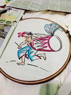 a cross - stitch pattern is being worked on with scissors