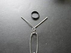 a pair of scissors sitting on top of a table next to a piece of wire