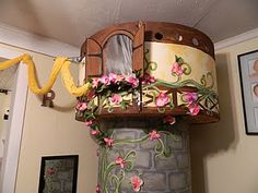 there is a decorative tower with flowers on the outside and inside it's roof